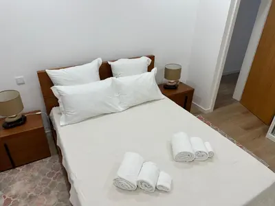 a bedroom with a bed with two towels on it at Refúgio Ponta do Sol - Madeira Inn Group in Ponta do Sol