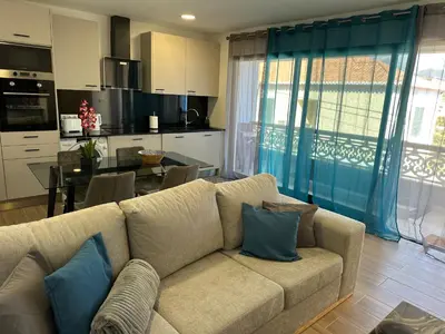 a living room with a couch and a dining room at Refúgio Ponta do Sol - Madeira Inn Group in Ponta do Sol