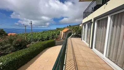 a balcony of a house with a view of the ocean at Casa Estrelada in Estreito da Calheta