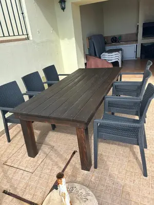 a wooden table and chairs in a living room at Casa Estrelada in Estreito da Calheta