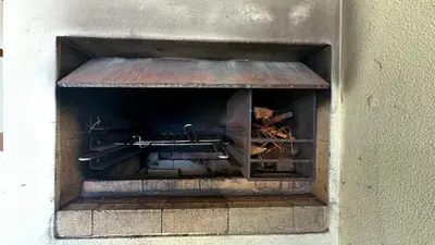 a brick oven filled with fire in a wall at Casa Estrelada in Estreito da Calheta