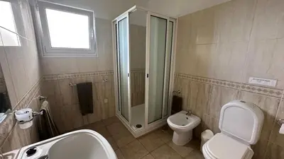 a bathroom with a shower and a toilet and a sink at Casa Estrelada in Estreito da Calheta