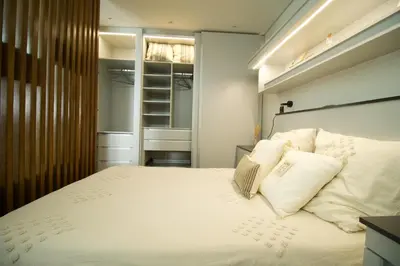 a bedroom with a large bed with white pillows at Modern Studio with Kitchen & Secure Parking in Funchal in Funchal