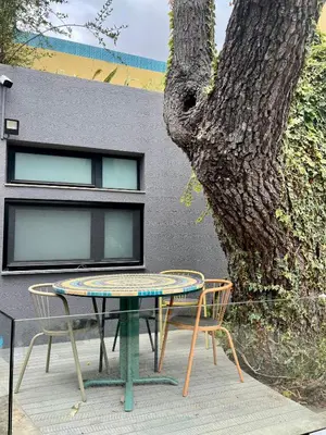 a table and two chairs sitting next to a tree at Modern Studio with Kitchen & Secure Parking in Funchal in Funchal