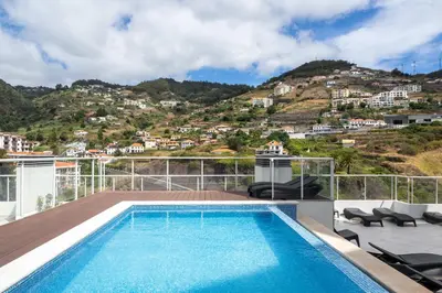 a swimming pool on the roof of a house at Madeira Ocean View by An Island Apart in Santa Cruz