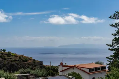 a view of the ocean from a house at Madeira Ocean View by An Island Apart in Santa Cruz