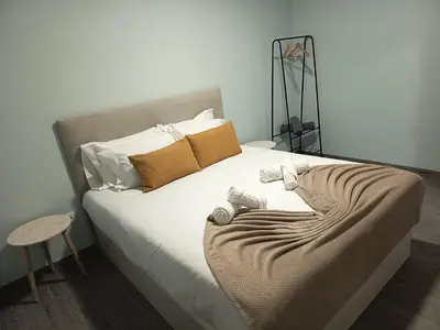 a bedroom with a bed with two stuffed animals on it at Pousada Teixeira 11A in São Vicente