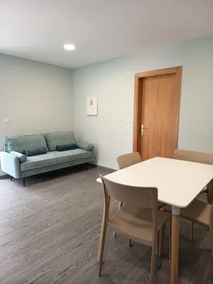 a living room with a couch and a table and chairs at Pousada Teixeira 11A in São Vicente