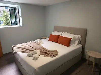a bedroom with a bed with towels on it at Pousada Teixeira 11B in São Vicente