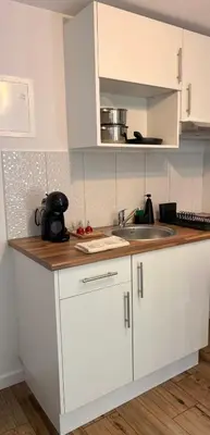 a kitchen with white cabinets and a sink at Old Aqueduct Village 2 - Guesthouse Madeira in Serra de Água