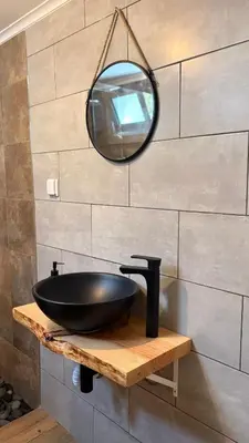 a bathroom with a black sink and a mirror at Old Aqueduct Village 2 - Guesthouse Madeira in Serra de Água