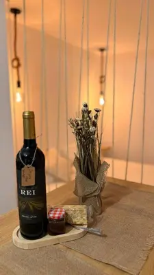 a bottle of wine and some flowers on a table at Old Aqueduct Village 2 - Guesthouse Madeira in Serra de Água