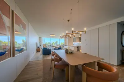 a kitchen and dining room with a wooden table and chairs at Savoy Monumentalis Ocean View By LM & AC Signature in Funchal