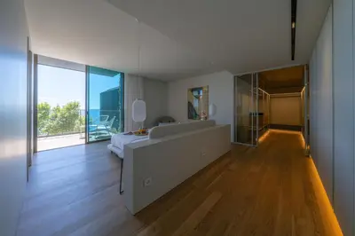 a bedroom with a bed and a large window at Savoy Monumentalis Ocean View By LM & AC Signature in Funchal