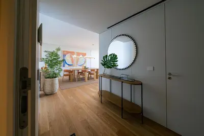 a living room with a mirror and a table at Savoy Monumentalis Ocean View By LM & AC Signature in Funchal