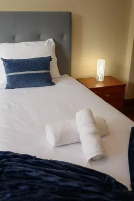 a white bed with two towels on top of it at Gorete Apartment 2 by Mth in Funchal