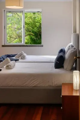 a bedroom with a large bed with a window at Gorete Apartment 2 by Mth in Funchal