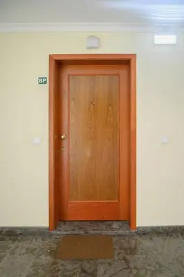 a wooden door in a white room with a floor at Gorete Apartment 2 by Mth in Funchal