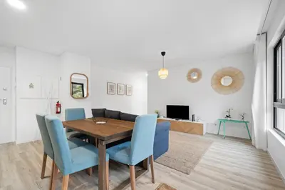a dining room with a wooden table and blue chairs at MK Apart II in Funchal