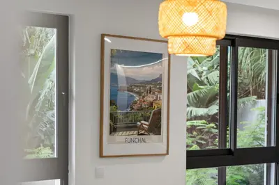 a picture hanging on a wall next to a window at MK Apart II in Funchal