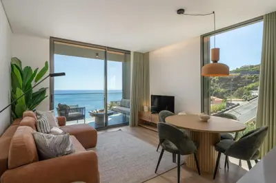 a living room with a couch and a table at Calheta Hills III by An Island Apart in Calheta