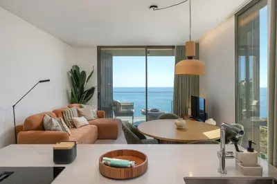 a living room with a couch and a table at Calheta Hills III by An Island Apart in Calheta