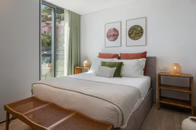 a bedroom with a large bed and a window at Calheta Hills III by An Island Apart in Calheta