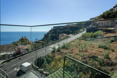 a view of a road with the ocean in the background at Calheta Hills III by An Island Apart in Calheta