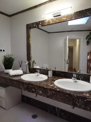 a bathroom with two sinks and a large mirror at Giraffa by Wanderlust Madeira - 3 Bedroom apartment in Funchal