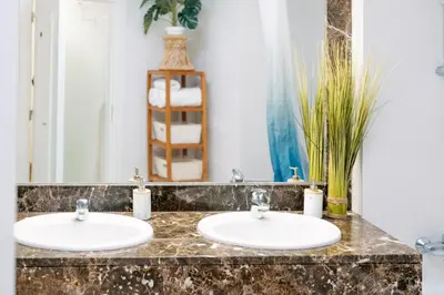 two sinks in a bathroom with a mirror at Giraffa by Wanderlust Madeira - 3 Bedroom apartment in Funchal
