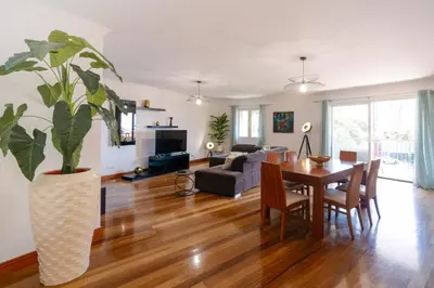 a dining room and living room with a table and a plant at Giraffa by Wanderlust Madeira - 3 Bedroom apartment in Funchal
