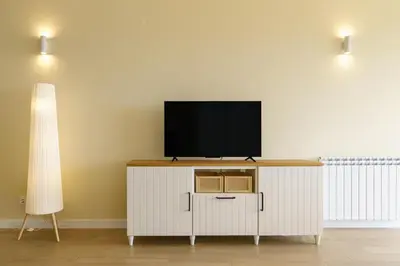 a white kitchen with white cabinets and a microwave at Villa Pargo Green by Madeira Dream Stays in Ponta do Pargo