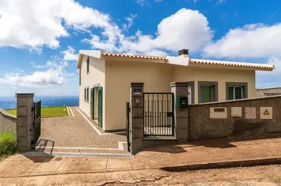 a dressing table and mirror in a room with a balcony at Villa Pargo Green by Madeira Dream Stays in Ponta do Pargo