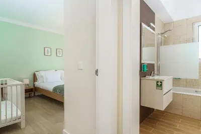 a bathroom with a tub and a sink and a mirror at Villa Pargo Green by Madeira Dream Stays in Ponta do Pargo