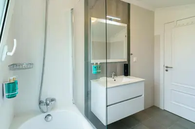 a bathroom with a white sink and a mirror at Villa Pargo Green by Madeira Dream Stays in Ponta do Pargo