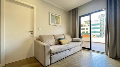 a living room with a couch and a sliding glass door at Sea and Sun 4 You - BeatMann in Funchal