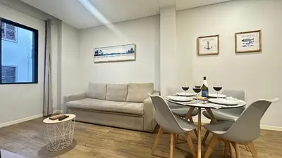 a living room with a table and a couch at Sea and Sun 4 You - BeatMann in Funchal