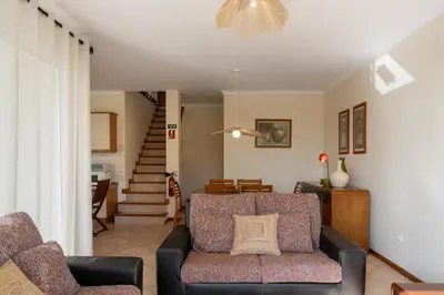a living room with a couch and a staircase at Gonçalves Guest House by An Island Apart in Porto Santo