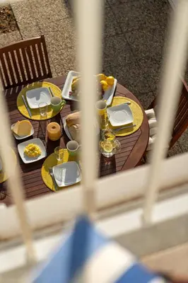 a wooden table with plates of food on it at Gonçalves Guest House by An Island Apart in Porto Santo