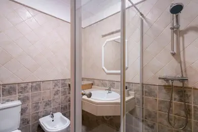 a bathroom with a toilet and a sink and a shower at Gonçalves Guest House by An Island Apart in Porto Santo