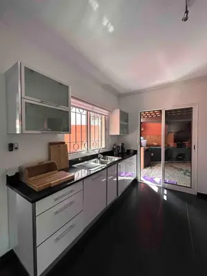 a kitchen with white cabinets and a counter top at VILLA Valhalla Private heated swimming-pool in Funchal