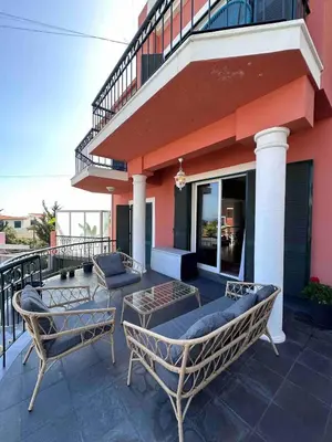 a patio with chairs and tables on a building at VILLA Valhalla Private heated swimming-pool in Funchal