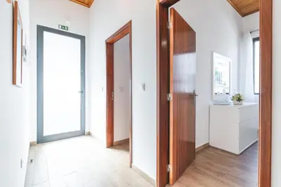 an open hallway with a wooden door and a room at Villa Magnolia by Atlantic Holiday in Machico