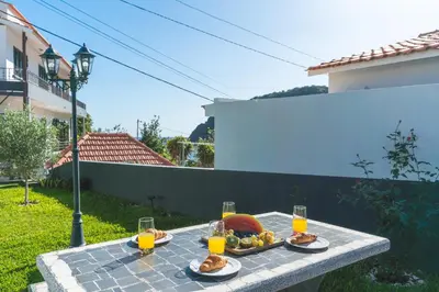 a table with food and glasses of orange juice at Villa Magnolia by Atlantic Holiday in Machico