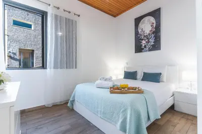 a bedroom with a bed with a tray of food on it at Villa Magnolia by Atlantic Holiday in Machico