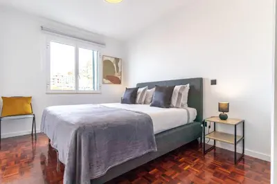 a bedroom with a large bed and a window at Carmo Lookout in Câmara de Lobos
