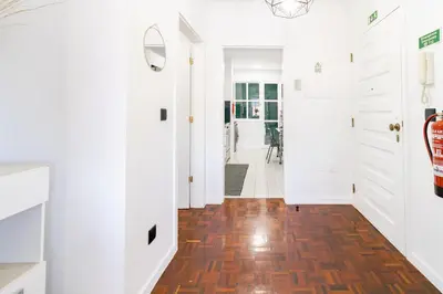 a hallway with white cabinets and a hardwood floor at Carmo Lookout in Câmara de Lobos