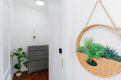 a basket with plants in it hanging on a wall at Carmo Lookout in Câmara de Lobos