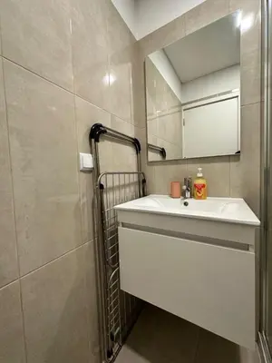 a bathroom with a white sink and a mirror at Valhalla Madeira Apartements in Funchal