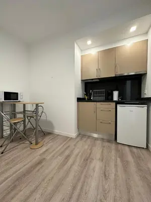 an empty room with a kitchen and a table at Valhalla Madeira Apartements in Funchal